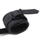 Black Wrist Cuffs with a Pull Handle from Kinky Puppy.