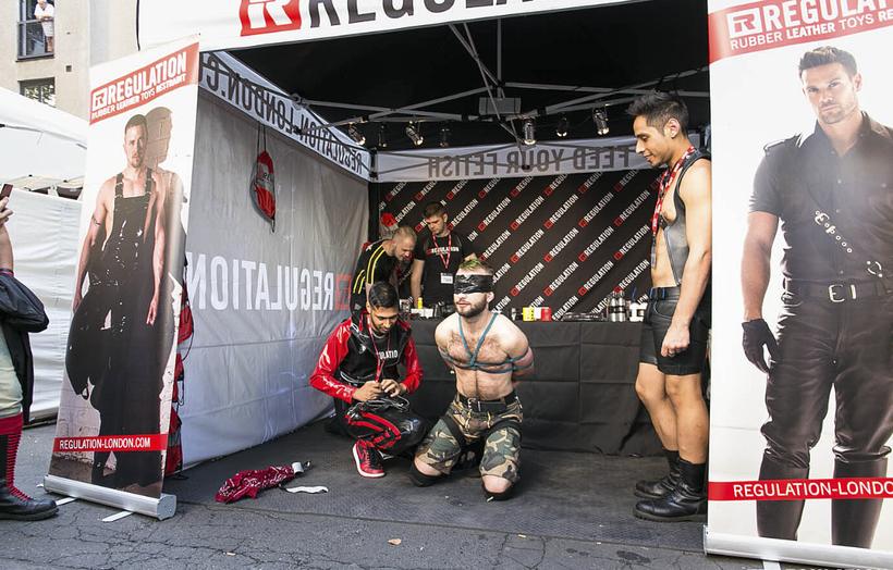 The REGULATION stall outdoors at a street festival, staff and visitors