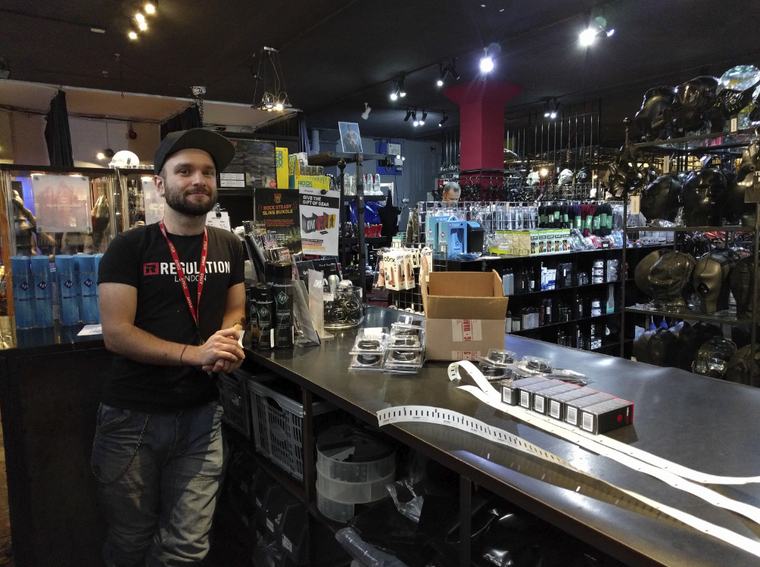 A REGULATION staff member behind the shop counter